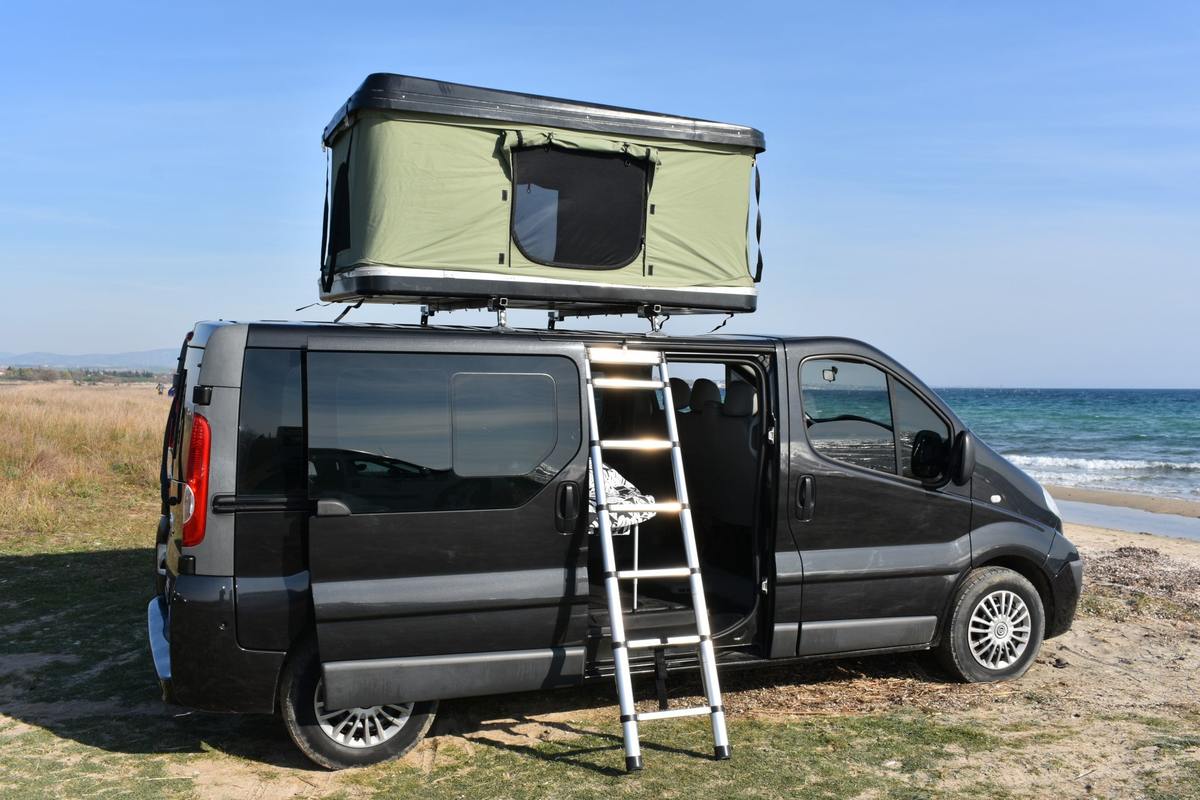 Camper with roof tent on the beach