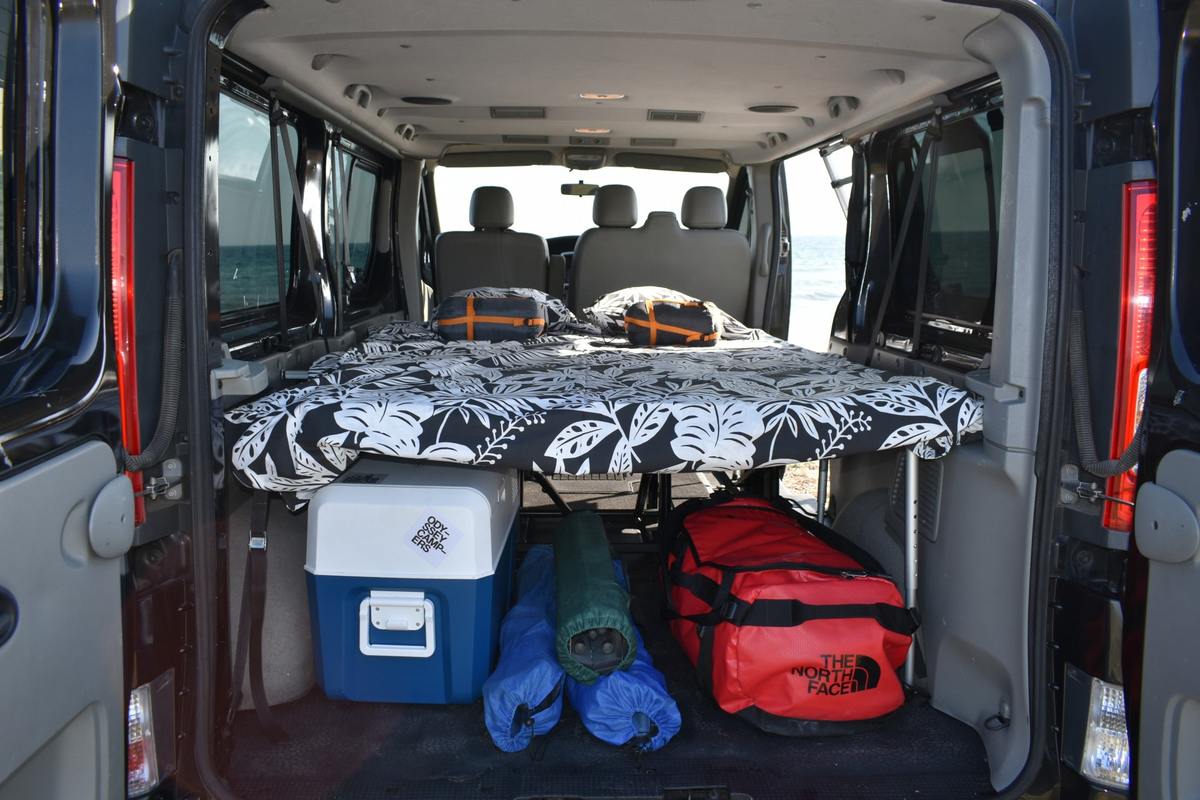 Bed and luggage area of Nissan camper